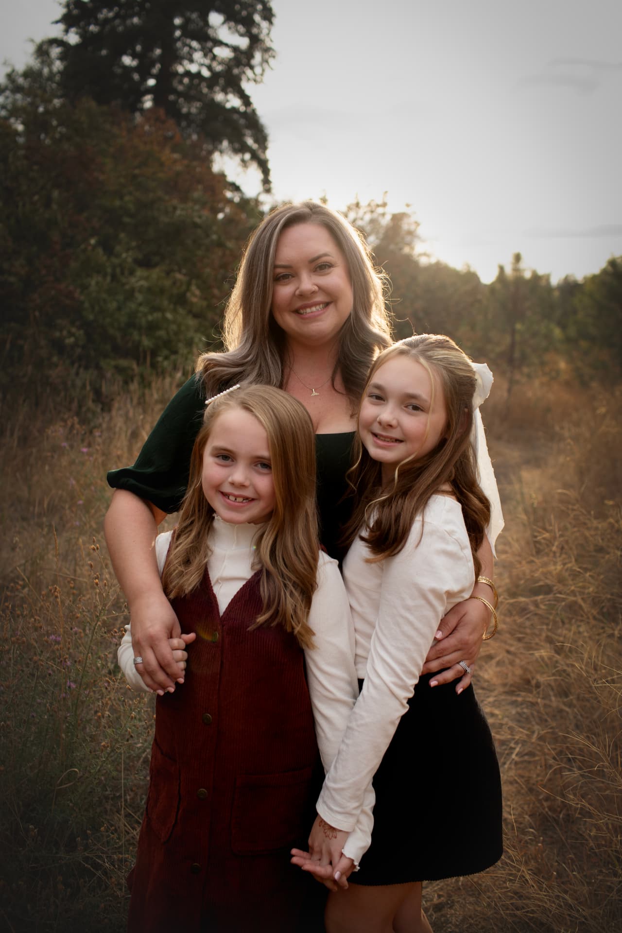 Mother with her two daughters in golden evening light